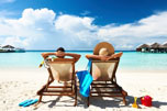 Couple Sitting on a beach in chairs